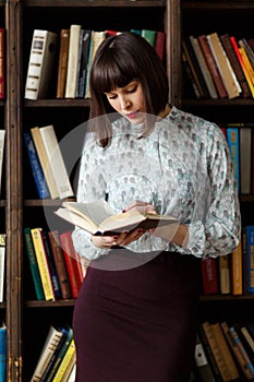 Photo of young brunette with book in hand