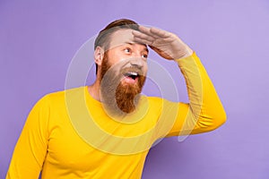 Photo of young businessman wear shirt hand forehead searching looking empty space far away adventures isolated on purple