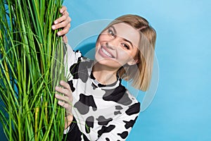 Photo of young charming girl hide growing natural plant green grass support ecological startup wear cowskin top isolated photo