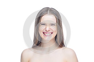 Photo of a young charming girl who smiles and laughs with joy and surprise, isolated on a white background