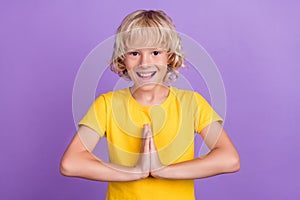 Photo of young charming happy positive boy hold hand together ask beg gift  on purple color background