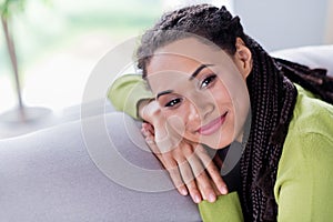 Photo of young charming relaxed woman sit sofa smile enjoy weekend indoors inside house home