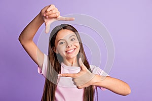 Photo of young cheerful girl happy positive smile make fingers border frame photographer cadre isolated over purple