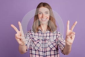 Photo of young cheerful girl happy positive smile show peace cool v-sign isolated over violet color background