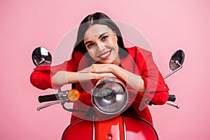 Photo of young cheerful girl happy positive smile sweet lovely sit motorbike isolated over pink color background