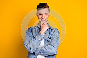 Photo of young cheerful guy arm touch chin thoughtful clever barber shop isolated over yellow color background