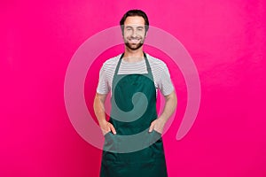 Photo of young cheerful guy arms in pocket confident hairdresser gardener isolated over magenta color background