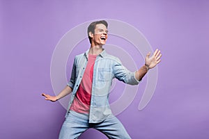 Photo of young cheerful guy happy positive smile have fun dance party isolated over purple color background