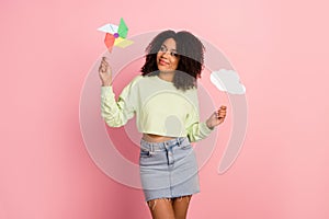 Photo of young cheerful lady have fun hold paper stick windmill bubble isolated over pink color background