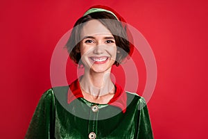 Photo of young cheerful woman happy positive smile elf santa helper new year isolated over red color background