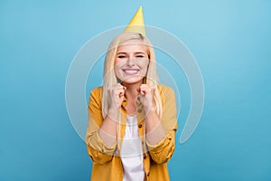 Photo of young cheerful woman happy positive smile rejoice victory cone celebration isolated over blue color background
