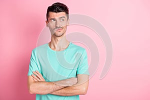 Photo of young confident serious man crossed hands think look empty space isolated over pink color background