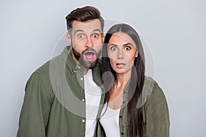 Photo of young couple astonished fake gossip stupor face reaction isolated over grey color background