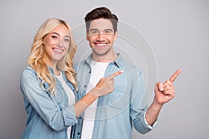 Photo of young couple happy positive smile indicate fingers empty space ad promo suggest isolated over grey color