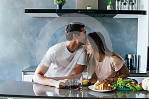 Photo of young couple starting the day together with coffee