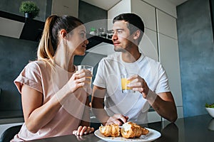 Photo of young couple starting the day together with coffee