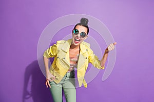 Photo of young crazy happy positive girl woman female pointing finger in copyspace isolated on violet color background