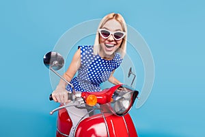 Photo of young excited girl happy positive smile drive motorbike wear sunglass isolated over blue color background