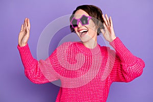 Photo of young excited girl happy positive smile have fun enjoy music dance wear sunglass isolated over violet color