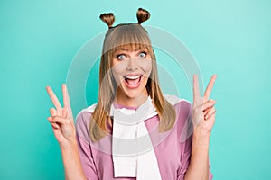 Photo of young excited girl happy positive smile show peace cool v-sign tight jumper isolated over turquoise color