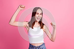 Photo of young excited girl rejoice victory fists hands triumph winner luck lottery isolated over pink color background