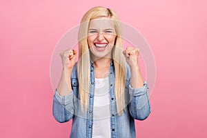 Photo of young excited lady rejoice victory fists hands win lottery isolated over pink color background