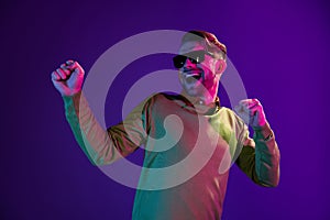 Photo of young excited man happy positive smile have fun dance music party hipster isolated over neon color background