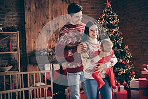 Photo of young family happy positive smile hold newborn child winter holiday decoration x-mas celebration indoors