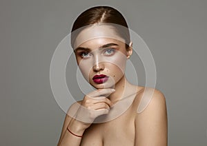 Photo of young fashion female model with moles on face