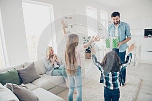 Photo of young foster family two children raising hands air receive unexpected giftbox glad to have best parents