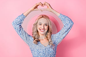 Photo of young girl blonde wavy hair wear blue trendy dress showing heart symbol fingers romantic day isolated on pink