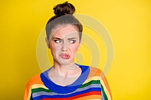 Photo of young girl disgusted dislike bad smell negative refused look empty space isolated over yellow color background photo