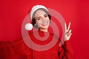 Photo of young girl happy positive smile show peace cool v-sign record video isolated over red color background