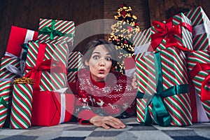 Photo of young girl lying floor gift pile impressed wear trendy red sweater festive interior living room presents