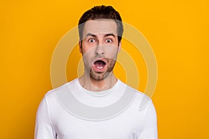Photo of young guy astonished crazy open mouth stupor face reaction isolated over yellow color background