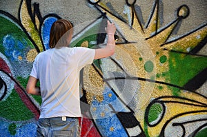 Photo of a young guy in denim shorts and a white shirt.