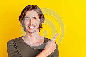 Photo of young guy indicate finger empty space ad advise recommendation isolated over yellow color background