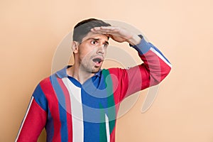 Photo of young guy staring when was searching food near his home palm forehead problems looking isolated on beige color