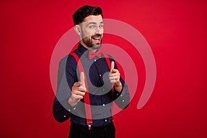 Photo of young handsome happy excited smiling cheerful man point finger you camera isolated on red color background