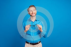 Photo of young handsome man happy positive smile dream look empty space isolated over blue color background