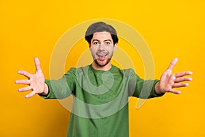 Photo of young happy amazed cheerful man open hands you welcome smile isolated on yellow color background