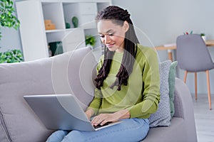 Photo of young happy cheerful afro american woman sit sofa hold hand laptop indoors inside house home