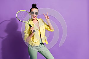 Photo of young happy cheerful positive beautiful girl woman female hold badminton rocket showing v-sign isolated on