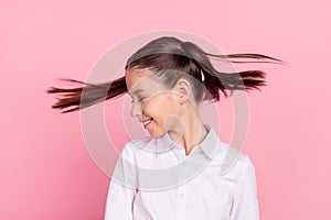 Photo of young happy positive cheerful girl fly hair wind blow smile enjoy pupil isolated on pink color background