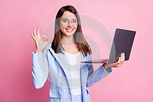 Photo of young happy smile girl hold laptop show okey deal done cool sign isolated over pastel color background