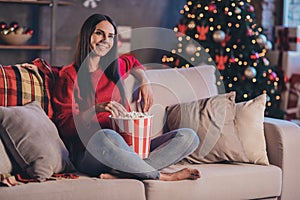 Photo of young happy smiling cheerful good mood woman sit sofa eat popcorn relax enjoy watch film on tv at home house