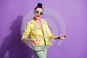 Photo of young happy smiling funky girl woman hold badminton racket like playing guitar isolated on violet color
