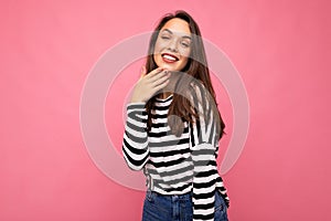Photo of young happy smiling positive beautiful brunette woman with sincere emotions wearing casual striped pullover