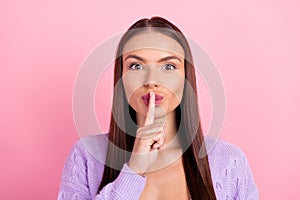 Photo of young happy voiceless woman hold finger lips mute secret isolated on pink color background