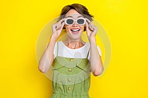 Photo of young hipster girl summertime vacation wear sunglasses rayban excited shocked how cool weekend isolated on photo